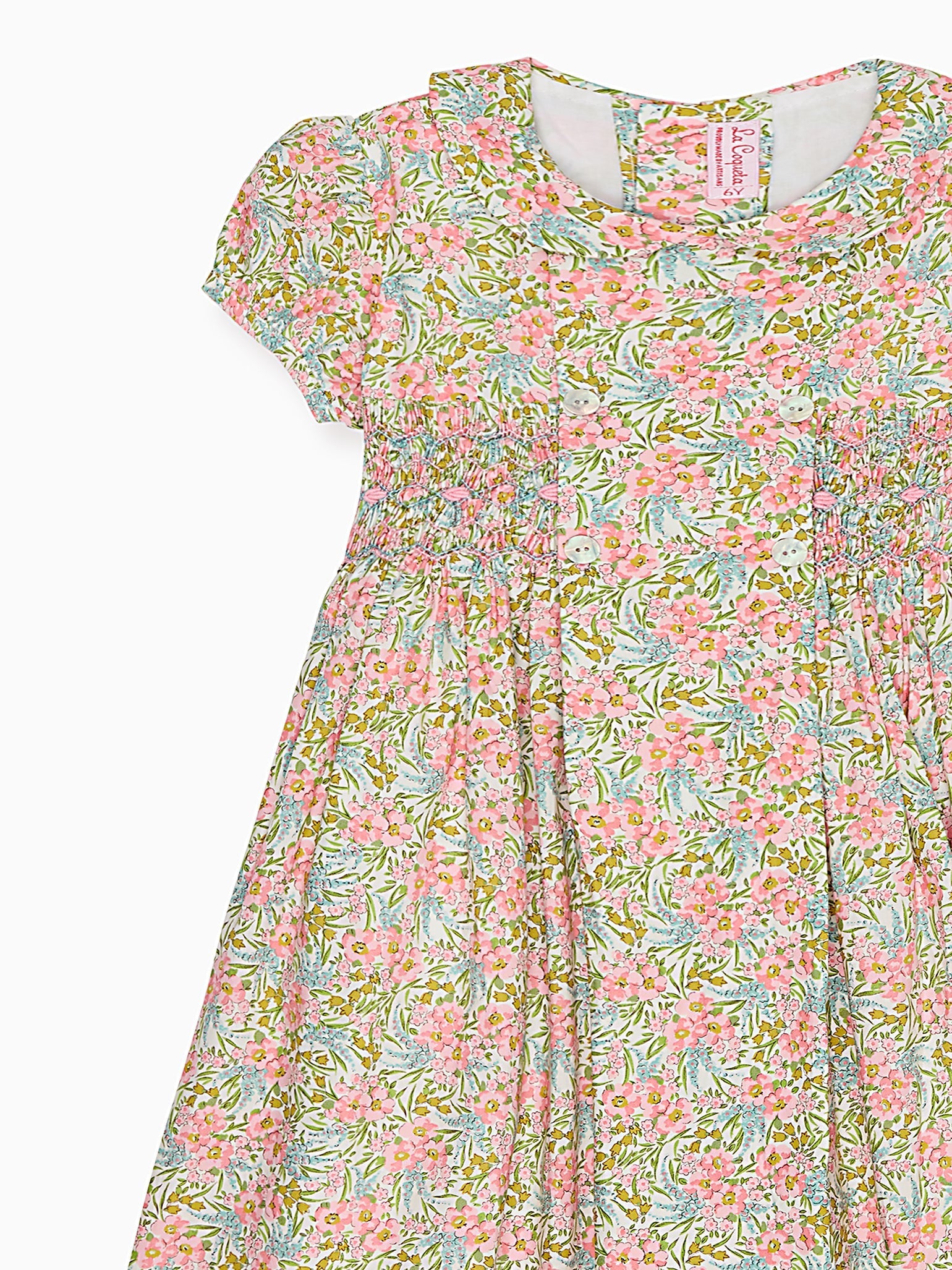 Robe fillette smockée main en tissu fleuri rose
